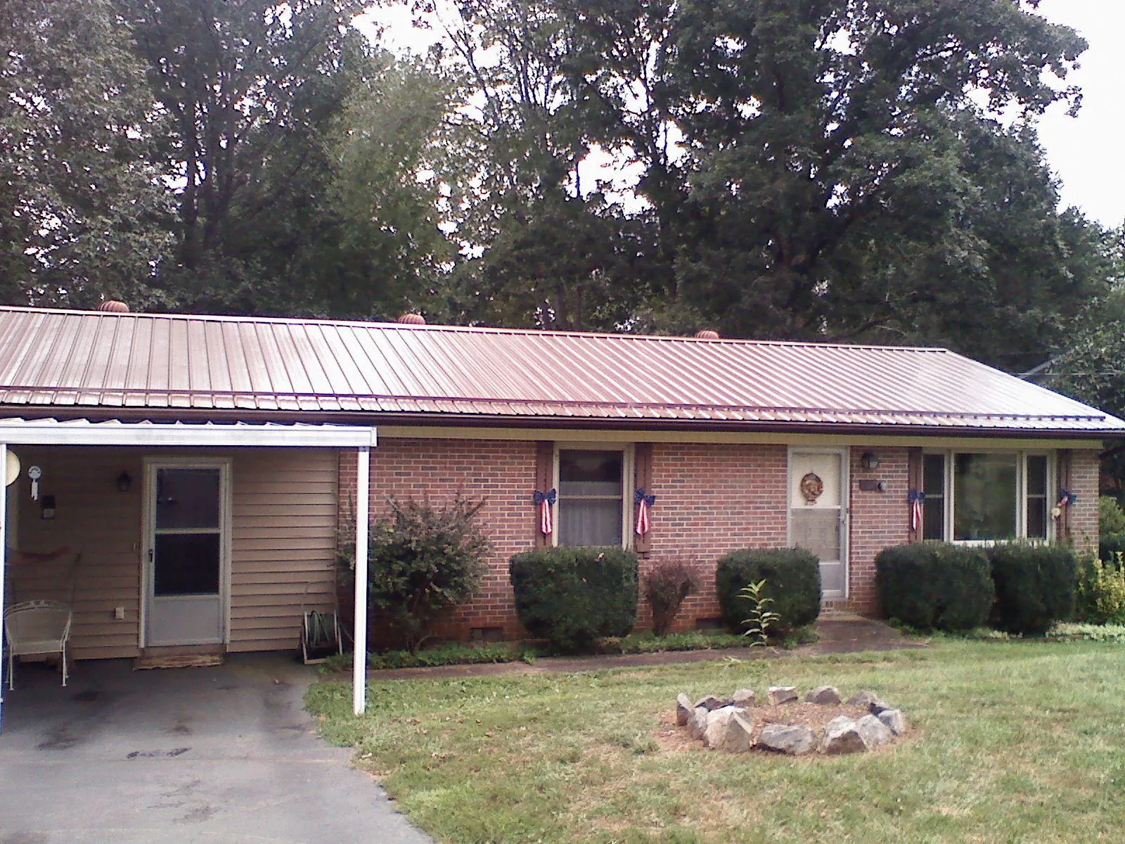Bronze metal roof and carport on a brick ranch home — Roof Repair work by our crew in Kenosha